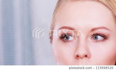 Portrait of blonde woman with grey blue eyes 115698520