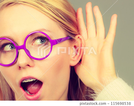 Woman listening carefully with hand close to ear 115698538