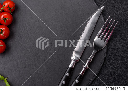 Empty round slate plate for template on the black background Empty round slate plate for template on the black background 115698645