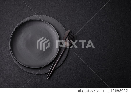 Empty round slate plate for template on the black background Empty round slate plate for template on the black background 115698652
