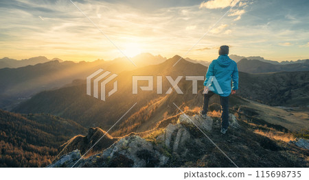 Man on stone on the hill and beautiful mountain valley Man on stone on the hill and beautiful mountain valley 115698735