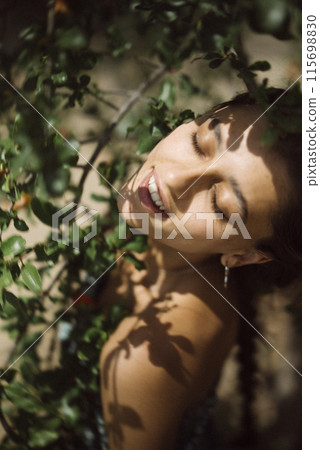 A Woman with a Joyful Smile in the Heart of a Serene and Stunning Natural Environment 115698830