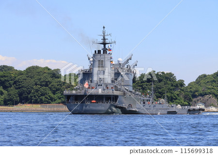 Maritime Self-Defense Force vessel pushed by a tugboat, approaching the shore Maritime Self-Defense Force vessel pushed by a tugboat, approaching the shore 115699318