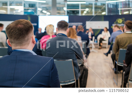 Business conference with attendees sitting and listening to speakers Business conference with attendees sitting and listening to speakers 115700032