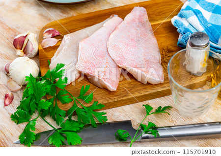 Raw rockfish fillet with condiments, food preparation Raw rockfish fillet with condiments, food preparation 115701910