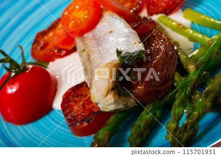 Blue whiting fish baked with dried tomatoes Blue whiting fish baked with dried tomatoes 115701931