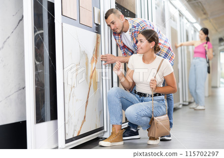 Construction store - married couple chooses ceramic flooring 115702297