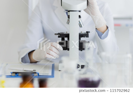 Woman in a white coat doing research Experiment Microscope Woman in a white coat doing research Experiment Microscope 115702962