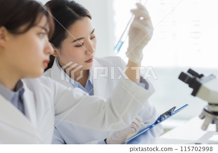 Woman in a white coat doing research Experiment Microscope Woman in a white coat doing research Experiment Microscope 115702998