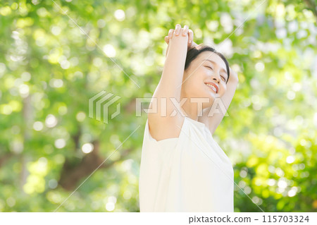 A woman stretching in the greenery 115703324
