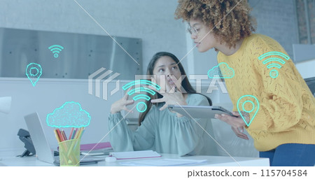 Wi fi, cloud and gps icons over diverse female colleagues in discussion at laptop in casual office 115704584