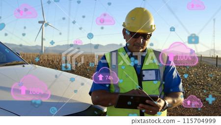 Digital network concept shown with engineer, wind turbines, and pink clouds. 115704999
