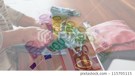 Image of Euro bills lying on a table over Caucasian woman sewing face masks 115705115