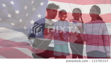 Image of flag of united states of america over biracial couple with children by seaside Image of flag of united states of america over biracial couple with children by seaside 115705337