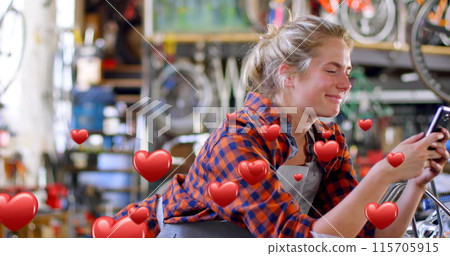 Female bike mechanic texts with hearts flying around her in a digital 4k composite. Female bike mechanic texts with hearts flying around her in a digital 4k composite. 115705915