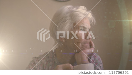 Image of glowing light over serious senior woman drinking tea 115706291