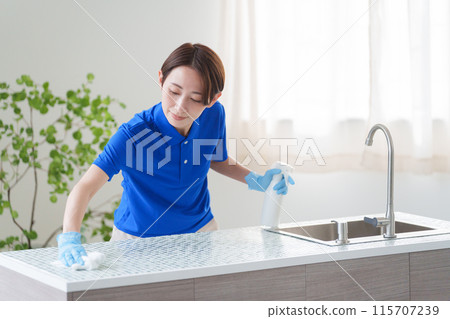 A female staff member of a cleaning company cleaning the kitchen (house cleaning/housekeeping service) A female staff member of a cleaning company cleaning the kitchen (house cleaning/housekeeping service) 115707239