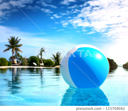 A beach ball floating in a pool against a blue sky (AI generated image) 115709082