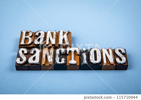 BANK SANCTIONS. Wooden alphabet letter blocks on blue textured background BANK SANCTIONS. Wooden alphabet letter blocks on blue textured background 115710944