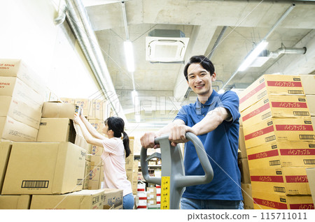 Young man working in a warehouse Young man working in a warehouse 115711011