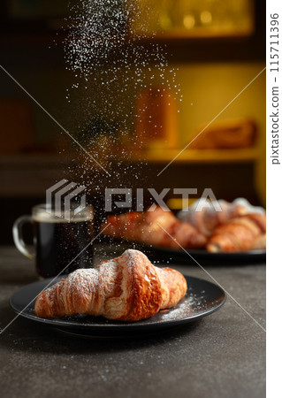 Croissants sprinkled with sugar powder. Croissants sprinkled with sugar powder. 115711396