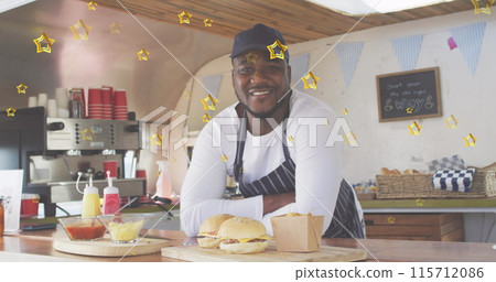 Image of gold stars over happy african american male food vendor in food truck 115712086