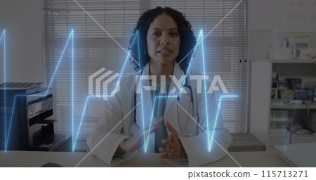 Image of cardiograph over happy biracial female doctor having image call 115713271