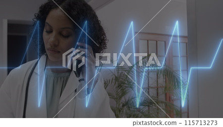 Image of cardiograph over happy biracial female doctor talking on smartphone 115713273