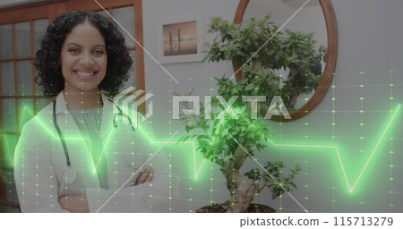 Image of cardiograph over happy biracial female doctor with stethoscope 115713279