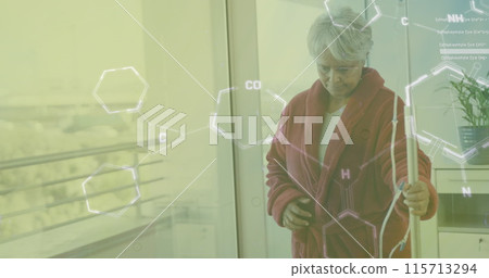 Image of chemical formula over senior biracial female patient walking with drip 115713294