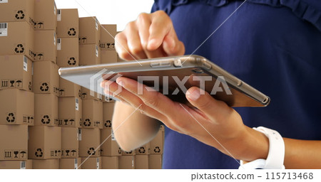 Image of man using tablet with stacks of boxes on white background 115713468