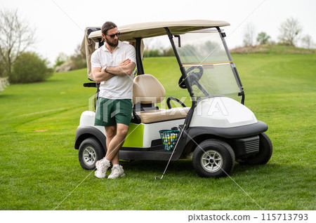 Handsome man making training on the golf course standing near car 115713793