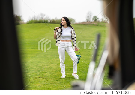 Woman playing golf at golf course enjoying leisure time 115713833