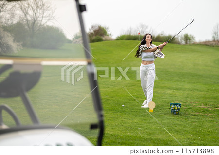 Joyful girl golfer playing golf in nature during the summer 115713898