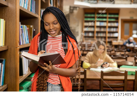 Long-haired young african american woman in the library 115714054