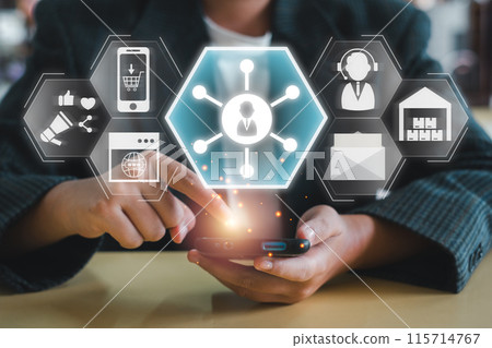 Businessman using smartphone with digital icons representing omni channel concept for seamless customer experience and integrated marketing strategy. Businessman using smartphone with digital icons representing omni channel concept for seamless customer experience and integrated marketing strategy. 115714767