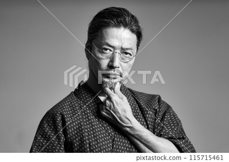 A man in a work uniform looking at something, senior craftsman, monochrome image 115715461