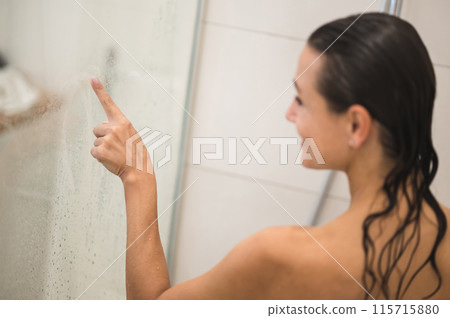 Waist up picture of a nude woman in a shower Waist up picture of a nude woman in a shower 115715880