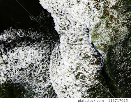 Overhead view dark stormy ocean waves with white foam in the ocean,Sea water with splashes and foam, Top view waves background, Natural background photo sea texture with waves soft focus Overhead view dark stormy ocean waves with white foam in the ocean,Sea water with splashes and foam, Top view waves background, Natural background photo sea texture with waves soft focus 115717015
