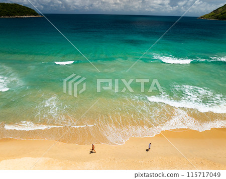 Top view beach with waves crashing on sandy shore,Beautiful waves sea surface in summer seascape background,Amazing beach colorful water background 115717049