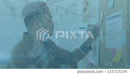 Image of financial data processing over man with face mask writing on memo note Image of financial data processing over man with face mask writing on memo note 115717234