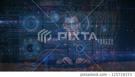 Image of cyber attack warning text and data processing over male hacker 115718153
