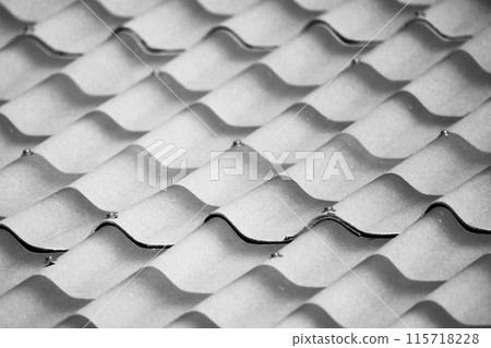 Imitation of roof tiling from corrugated sheets of slate, close up 115718228