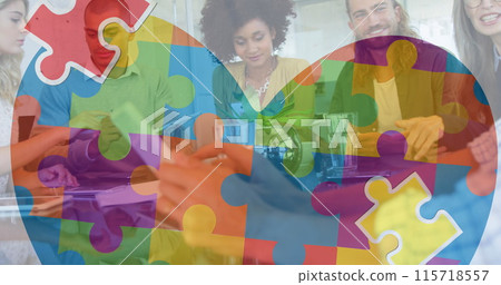 Image of colourful puzzle pieces heart over business colleagues with electronic devices 115718557