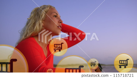 Image of shopping icons over midsection of caucasian woman using smartphone at beach 115718721