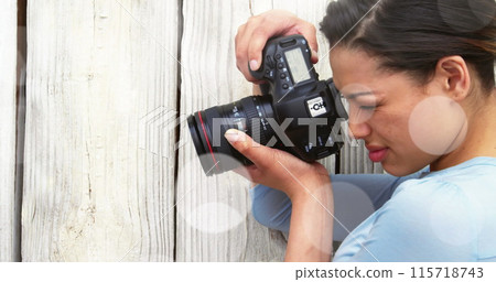 White spots against close up of caucasian female photographer clicking pictures with digital camera 115718743