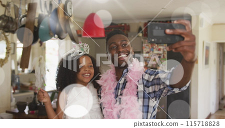 Image of spots over happy african american father with daughter using smartphone 115718828