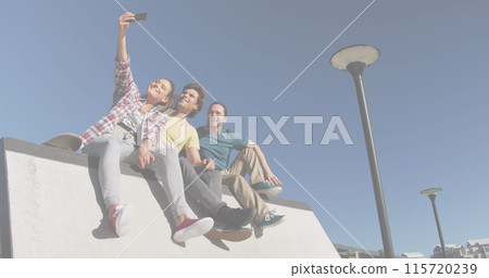 Image of colourful shapes over smiling caucasian friends 115720239