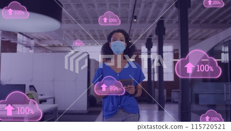 Image of clouds with uploading over biracial female doctor in face mask Image of clouds with uploading over biracial female doctor in face mask 115720521