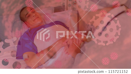 Image of a patient in hospital with coronavirus cells floating on the foreground 115721152
